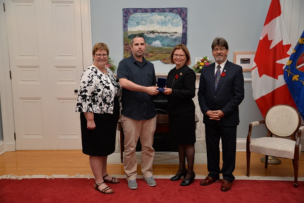Michael Vanin receiving the Governor General Academic Medal from Her Honourable Judy May Foote at Governor House